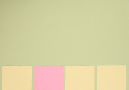 Empty Memo square sheets of paper on green backgroundの写真素材