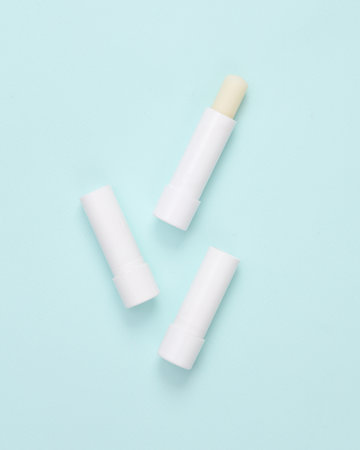 Lip balms on a blue background. personal hygieneの写真素材