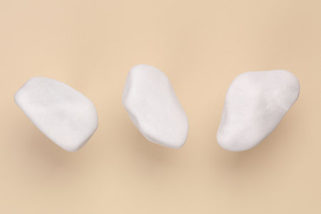 Soaring white pebbles on a beige backgroundの写真素材