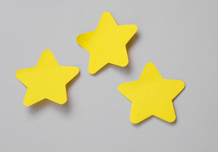 Three memo pieces in the form of stars on a gray backgroundの写真素材