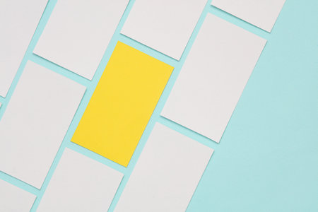 Yellow and white business cards on a blue background. Corporate identity, uniqueness conceptの写真素材