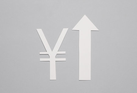 Cut out and paper yuan symbol with growth arrow going up on gray backgroundの写真素材