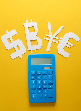 Calculator and paper-cut currency icons on yellow backgroundの写真素材