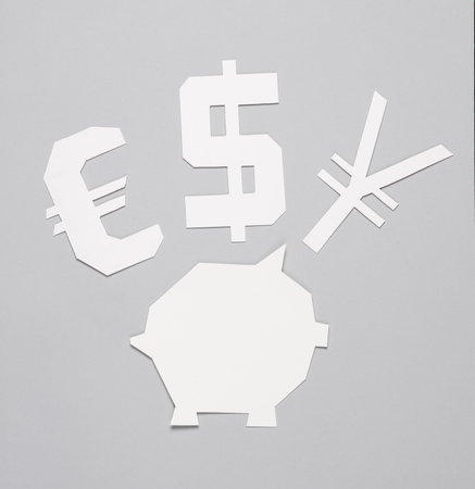 Piggy bank template and Symbols of different currencies cut out of white paper on gray background. finance conceptの写真素材