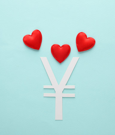 Yuan icon with hearts on blue backgroundの写真素材