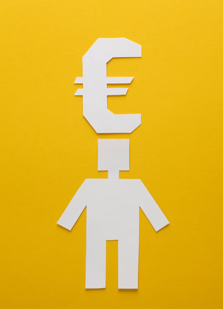 Paper cut man and euro symbol on yellow backgroundの写真素材