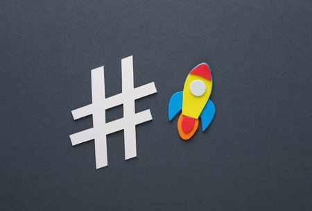 Paper-cut hashtag with rocket on gray background. startup conceptの写真素材