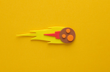 Toy handmade meteorite on a yellow background