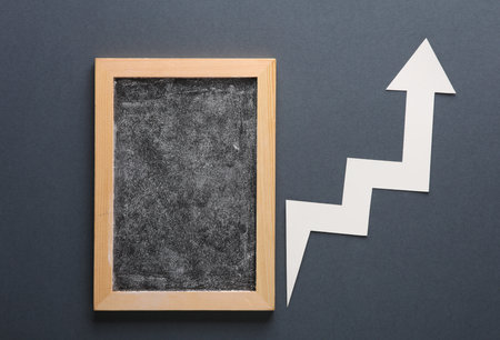 Chalk board with curve growth arrow on gray backgroundの写真素材