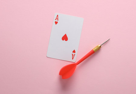Ace of hearts and dart, pink backgroundの写真素材