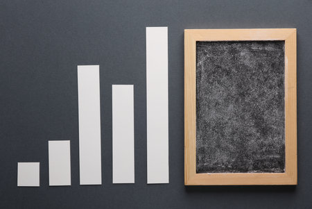 Bar chart with chalk board on gray backgroundの写真素材
