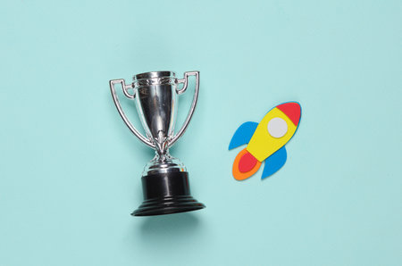 Winner cup space rocket on blue background