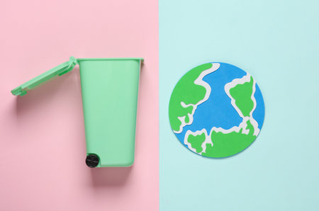 Trash can with the planet earth on pink blue background. Pollution, sorting, recycling concept