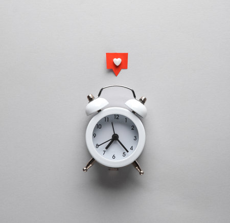 Alarm clock with Social media like on gray background. creative layoutの写真素材