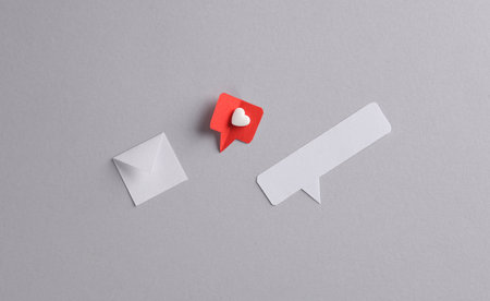 Paper cut notification message mail envelope with Social media like and speech bubble on gray background. creative minimalist layoutの写真素材
