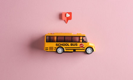 Toy school bus with Social media like on pink background. creative minimal layoutの写真素材