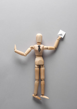 Businessman puppet with postal envelope on gray backgroundの写真素材