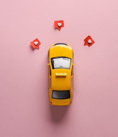 Toy taxi car with Social media like on pink background. creative minimal layoutの写真素材