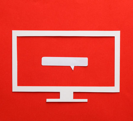 Paper cut tv with speech bubble on red backgroundの写真素材
