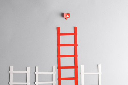 Paper cut Ladders with Social media like on gray background. creative minimal layout. popularity, leadership conceptの写真素材