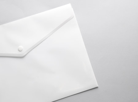 White plastic envelope folder on gray backgroundの写真素材