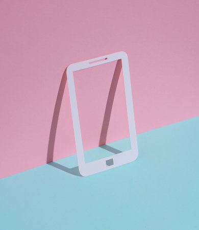 Paper-cut smartphone on blue-pink pastel backgroundの写真素材