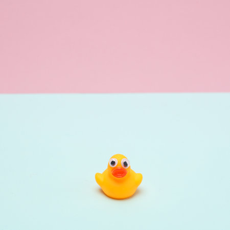 Rubber duck with goggle eyes on pink blue background. creative layoutの写真素材