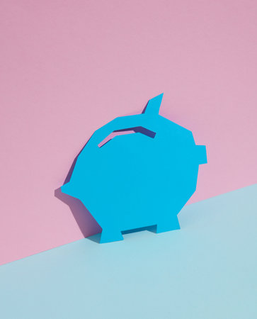 Paper-cut Piggy bank on blue-pink pastel background. creative layoutの写真素材