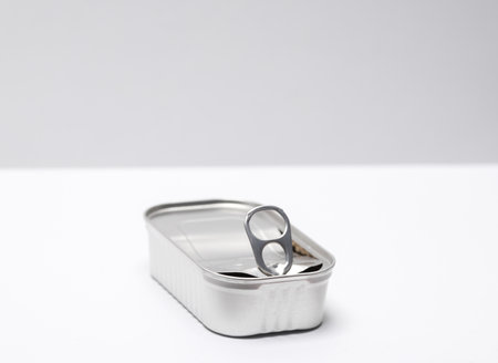 Open empty tin can on white gray background. top viewの写真素材