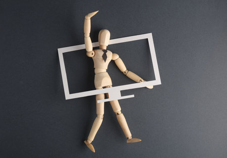 Propaganda. Wooden puppet broadcasts from TVの写真素材