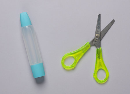Glue with scissors on a gray backgroundの写真素材