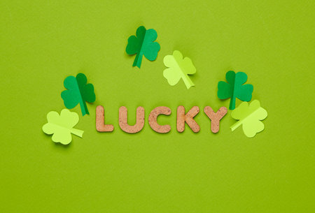 St.Patrick's Day. Word lucky with clover leaves on a green backgroundの写真素材