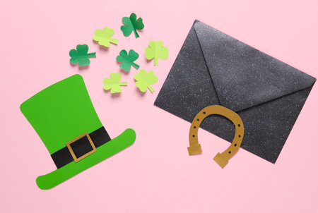 St. patrick's day invitation. Envelope with a festive themed hand-made decor on a pink background. flat layの写真素材