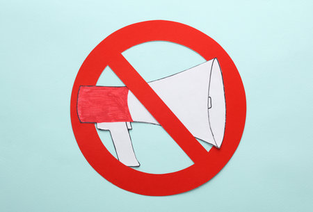 Paper cut megaphone with prohibition sign on a blue backgroundの写真素材