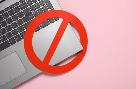 Laptop with prohibition sign on pink backgroundの写真素材
