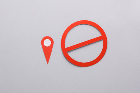 Geolocation point with a prohibition sign on a gray background.