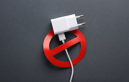 Charging block with a prohibition sign on a dark background