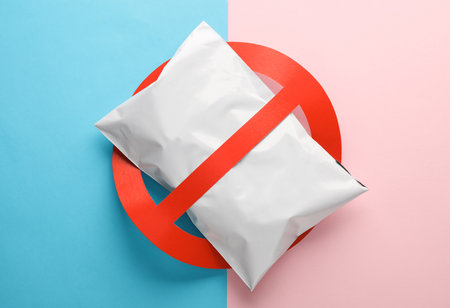 Postal package with a prohibition sign on a blue-pink backgroundの写真素材