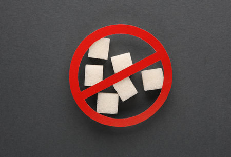 Sugar cubes with prohibition sign on dark backgroundの写真素材