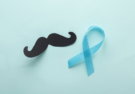 Paper mustache with blue awareness ribbon. Prostate Cancer Day. Man's healthの写真素材