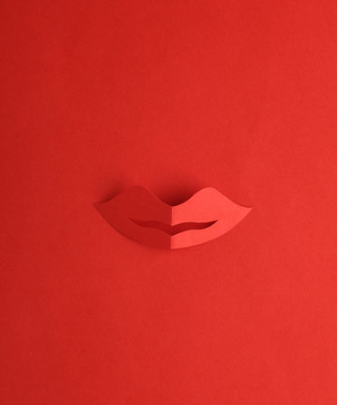 Paper-cut female red lips on a red backgroundの写真素材