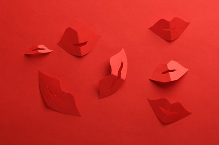 Paper cut red lips on red backgroundの写真素材