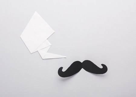 Paper men's mustache with a speech bubble on a gray backgroundの写真素材