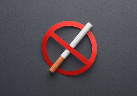 Cigarette with a prohibition sign on gray background. smoking banの写真素材