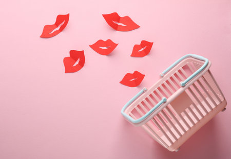 Supermarket basket with paper lips on a pink background. Saleの写真素材