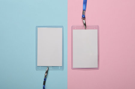 Empty white ID card badges mockup with blue belts on pink blue background. Staff identity name tags....