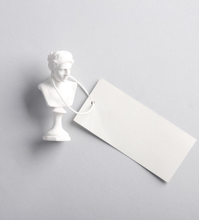 Venus bust with blank price tag on gray background