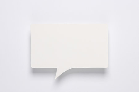White blank paper-cut speech bubble on white background. Chat, social media, discussion. Mock up template designの写真素材