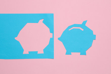 Paper-cut piggy bank on a pink backgroundの写真素材