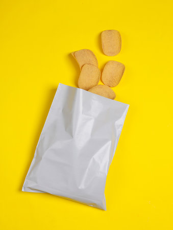 Mockup of open pack potato chips on yellow background. Template for designの写真素材